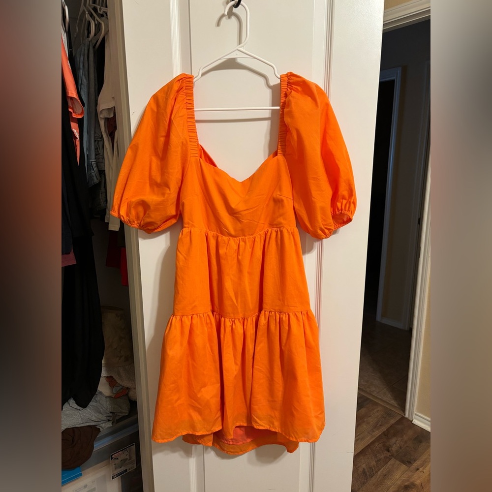 Orange dress with bow in back and puffy sleeves